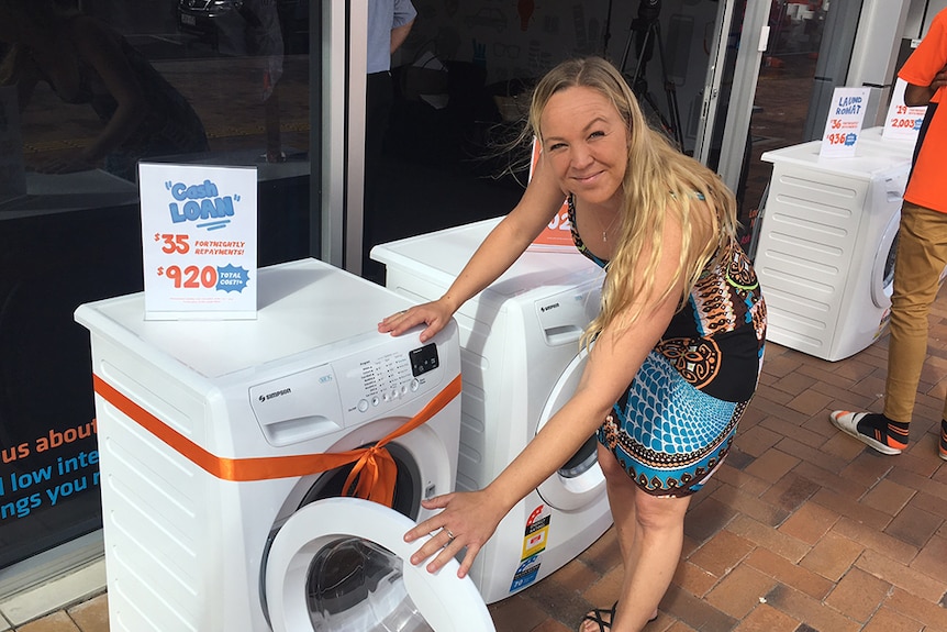 Gold Coast single mother Rachel Lewis checks out a washing machine