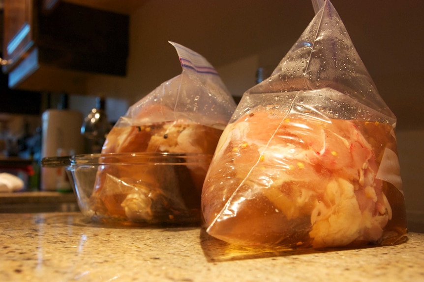 Chicken brining in bags.