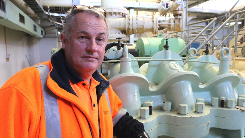 Mike Blackwell standing next to a pump in the Bryn Estyn water treatment plant, 20 August 2014.