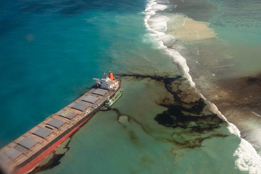Aerial view of oil tanker spilling oil into the sea at a reef near Mauritius