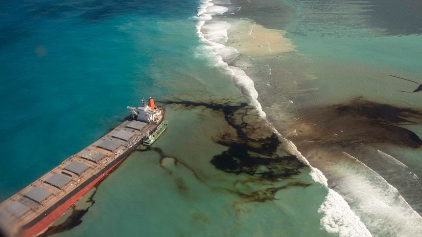 Aerial view of oil tanker spilling oil into the sea at a reef near Mauritius