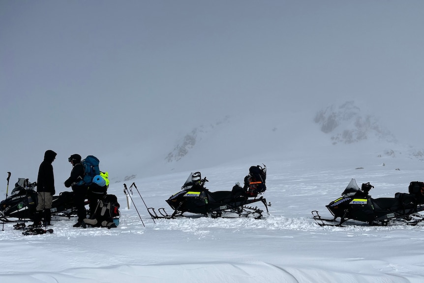 Snow mobiles and police in the snow