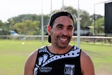 Eddie Betts smiles with goal posts in the background at Palmerston football oval.