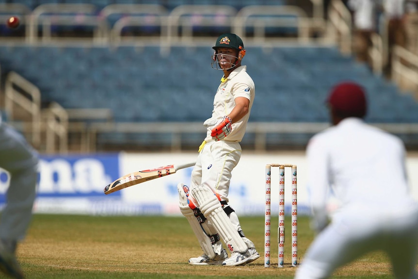 David Warner edges and is caught off the bowling of the West Indies' Jerome Taylor