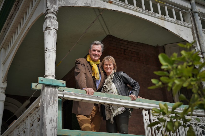 Jane and Steve Wilson smile from the verandah of Lamb House