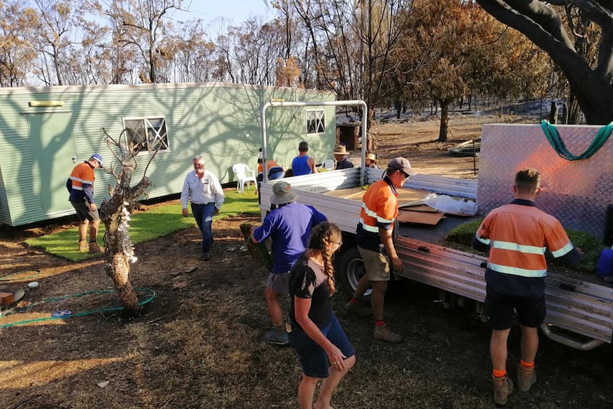 Members of the Yeppoon community help construct a donga for the Taylor family.