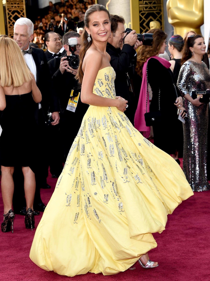 Actress Alicia Vikander walks the red carpet.