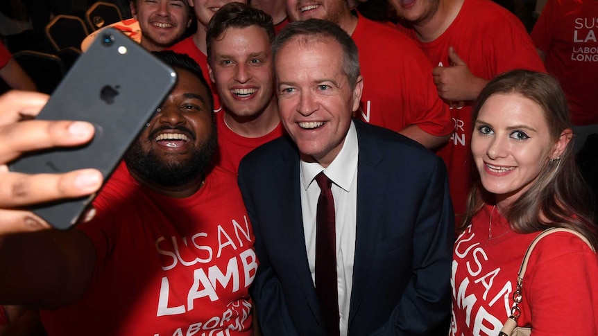 Bill Shorten joins Labor supporters for a selfie at an election after party