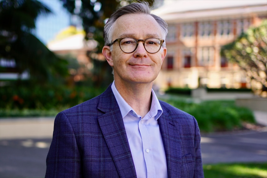 Bespectacled man wearing shirt and jacket