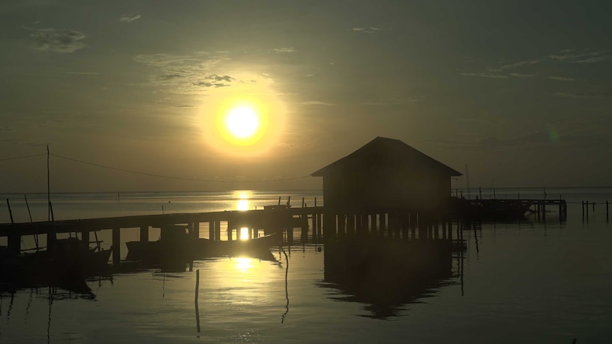 The sun sets on a fishing village in the Natuna Islands.