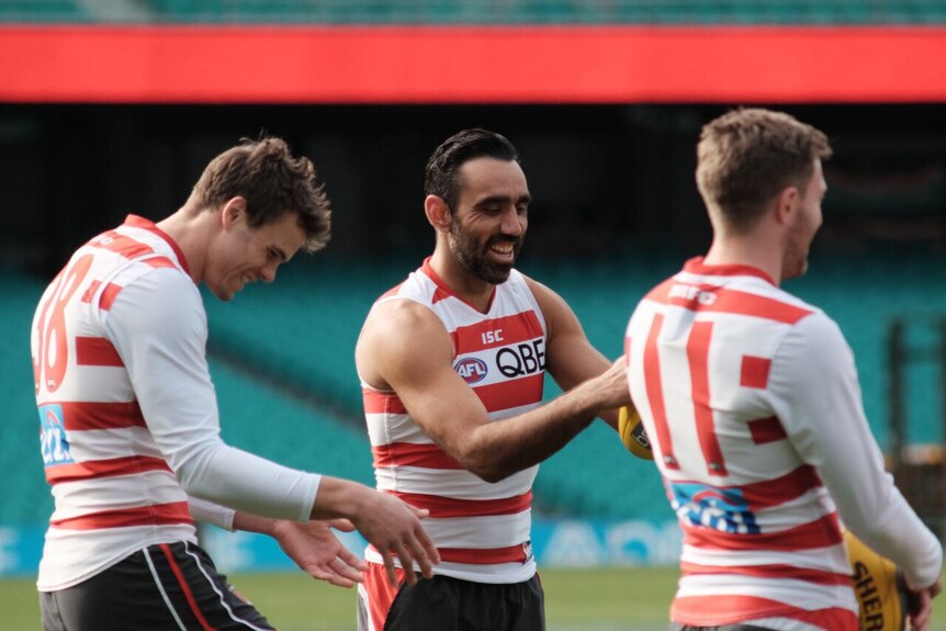 Adam Goodes laughs with team-mates at Swans training