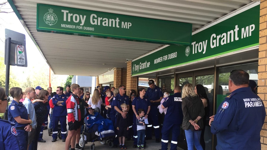 Paramedics line up outside the office of NSW Deputy Premier Troy Grant