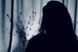 A silhouette of a woman with long hair.
