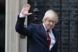 Newly appointed Foreign Secretary Boris Johnson waves as he leaves 10 Downing Street.