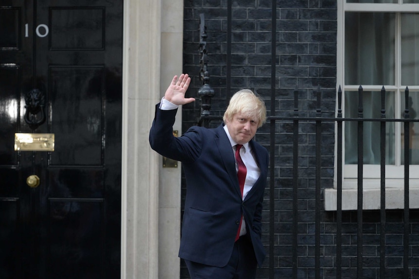 Newly appointed Foreign Secretary Boris Johnson waves as he leaves 10 Downing Street.