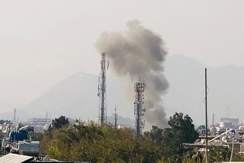 Smoke billows over a city. 