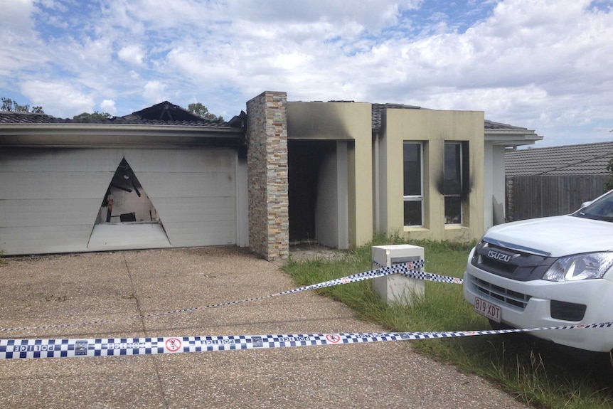 House at Holmview damaged by fire, with a giant hole opened in the garage