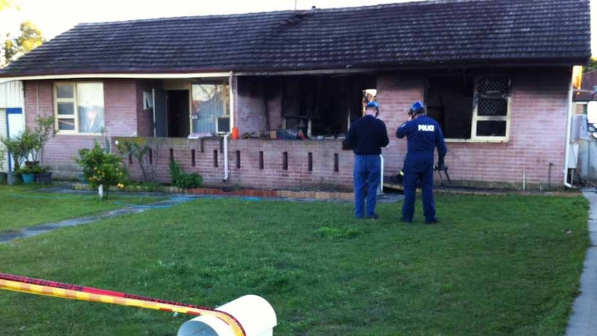 Police in front of burnt unit