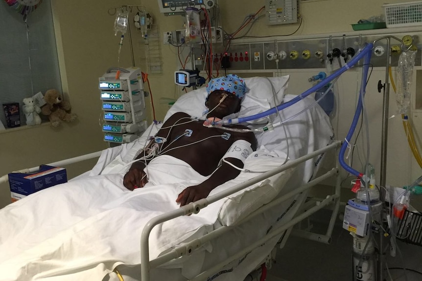 Yusuf Kamara lies in a hospital bed after his accident.