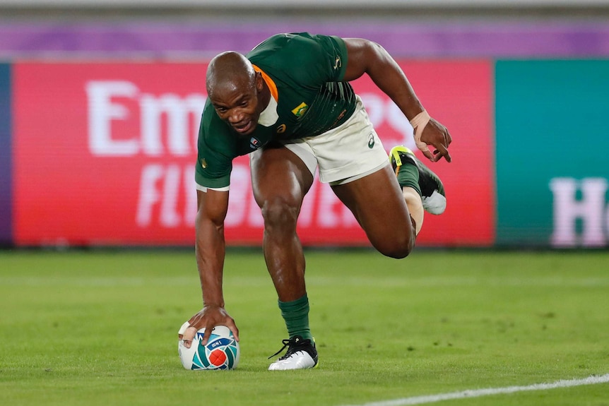 A South African rugby union player scores a try against England in the Rugby World Cup final.