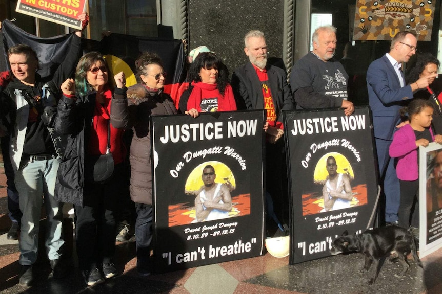 Protesters outside a court building