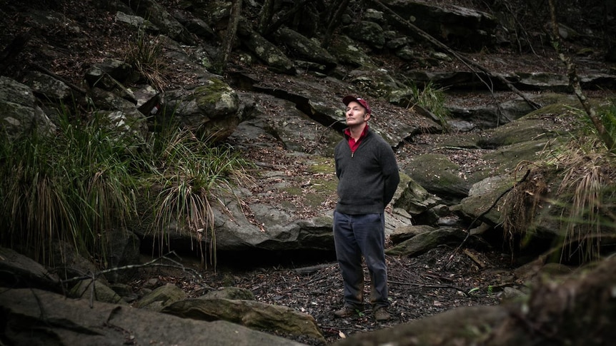 Man standing in dried up creek