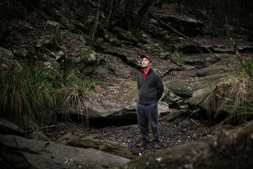 Man standing in dried up creek