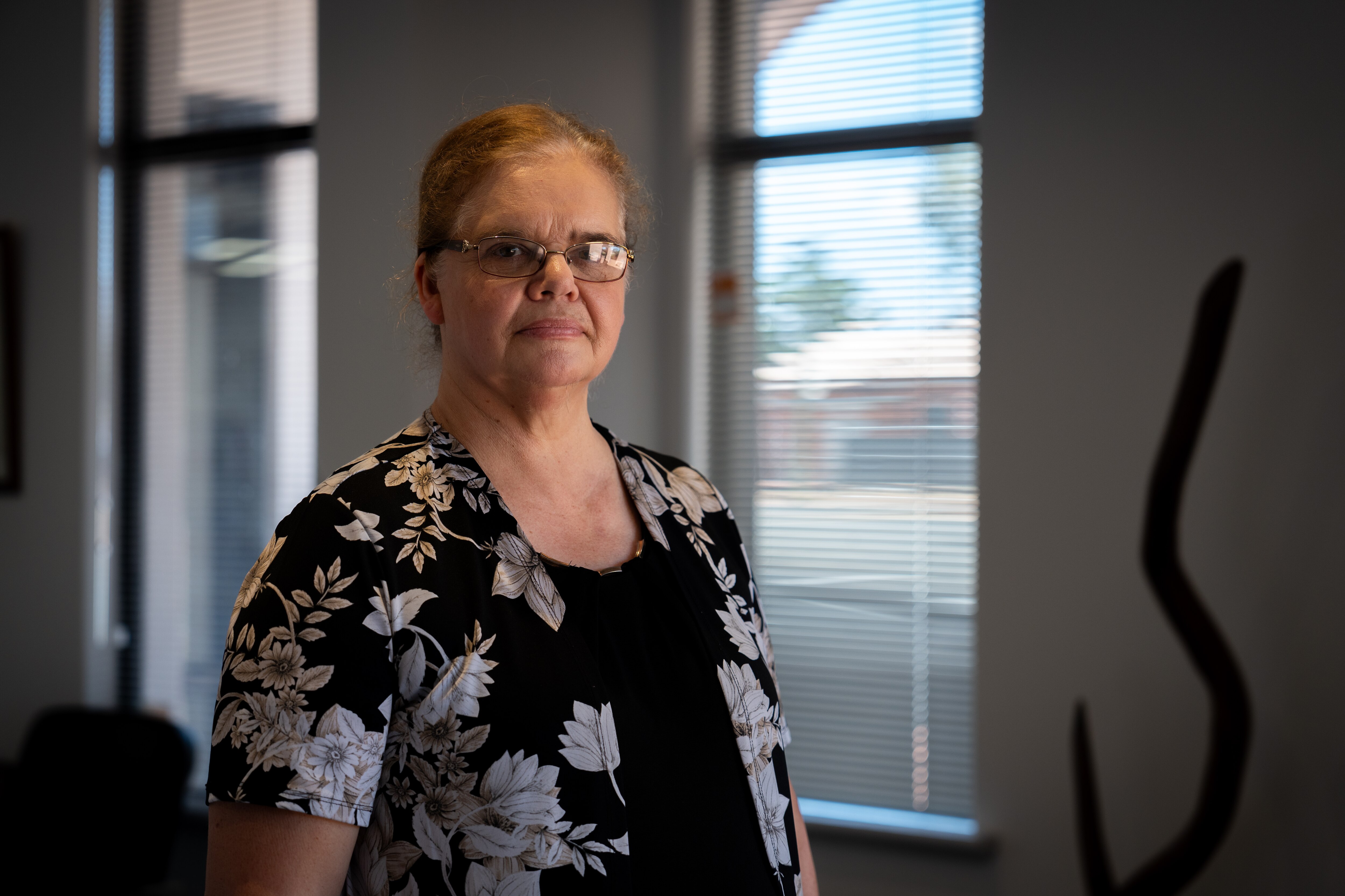 Jo Haythornthwaite standing in an office building with a neutral expression.
