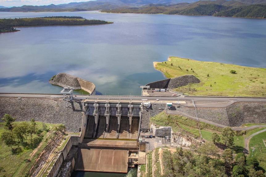 A dam wall near mountains.