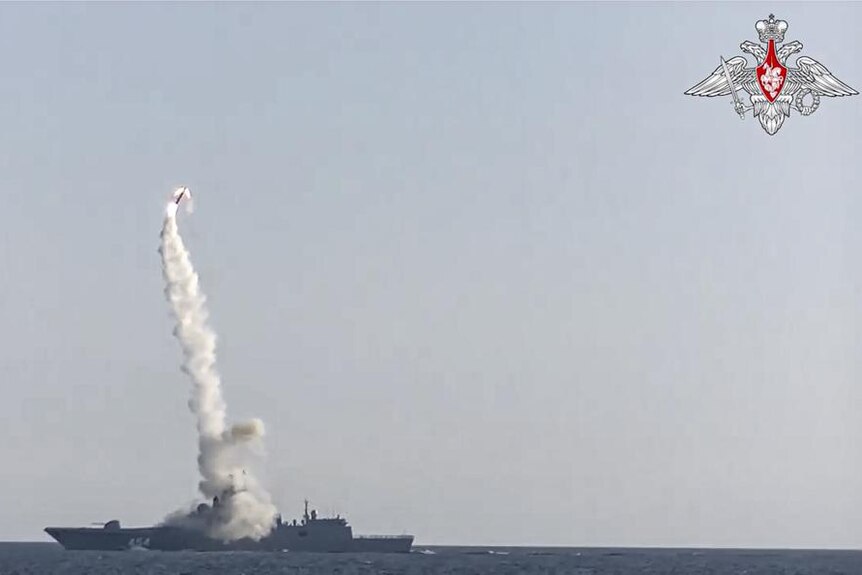 a rocket launches over the sea