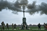 Ukrainian soldiers fire at Russian positions from a US-supplied M777 howitzer.