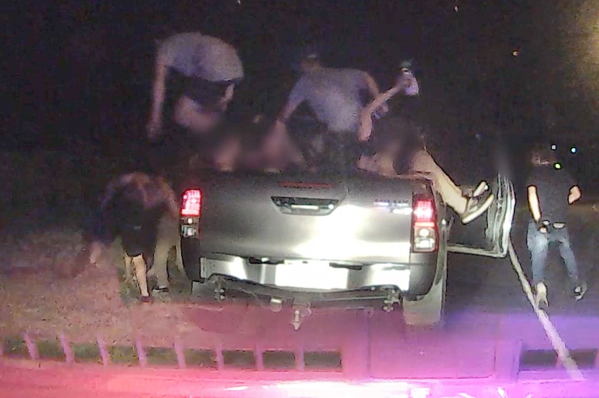 Young people scrambling out of an overcrowded four-wheel drive ute.