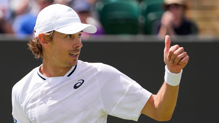 Alex de Minaur gives the thumbs up after a tennis match at Wimbledon.
