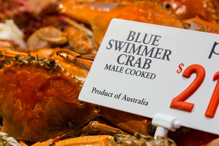 Price signage for blue swimmer crab at Sydney Fish Market.