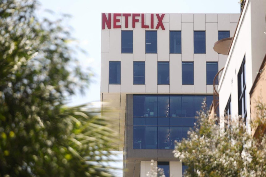 The facade of a large office building with the word 'Netflix' written in large, red letters along the top.