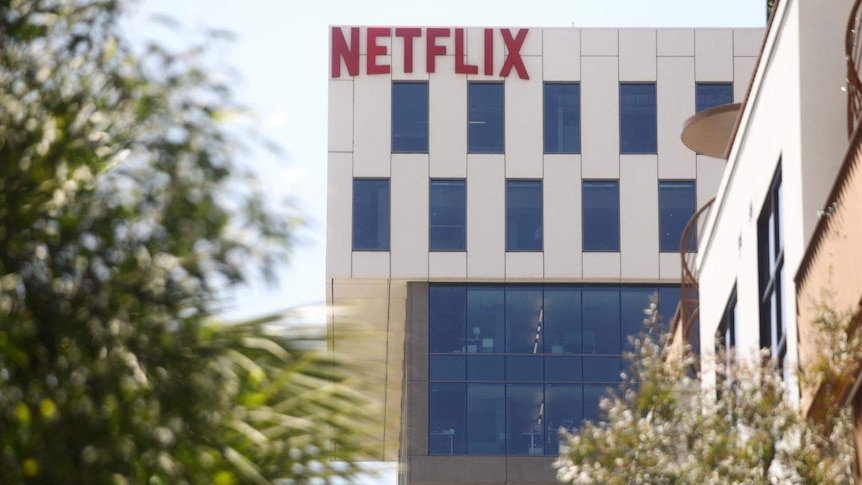 The facade of a large office building with the word 'Netflix' written in large, red letters along the top.