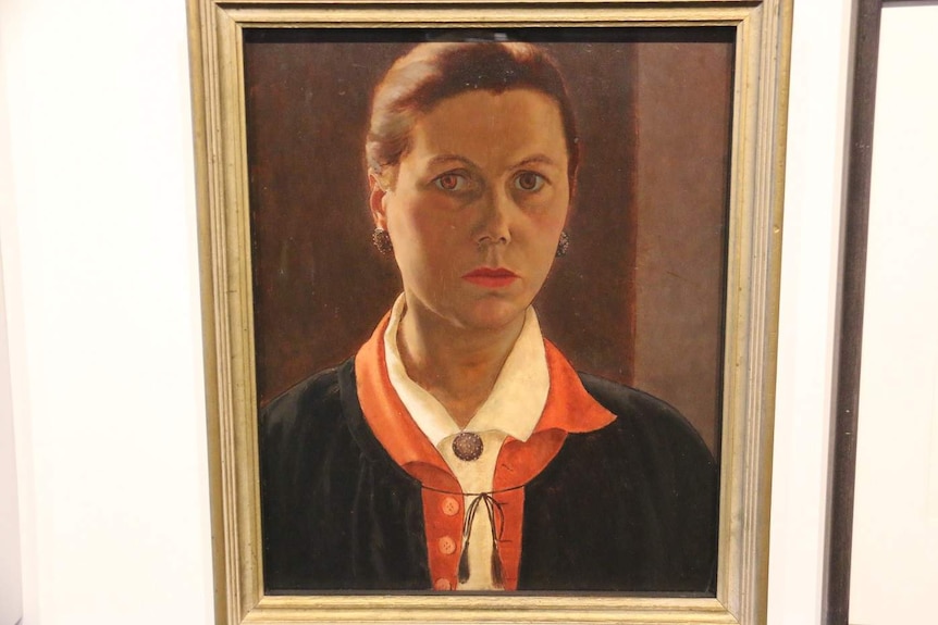 A portrait of Stella Bowen hangs on a wall.