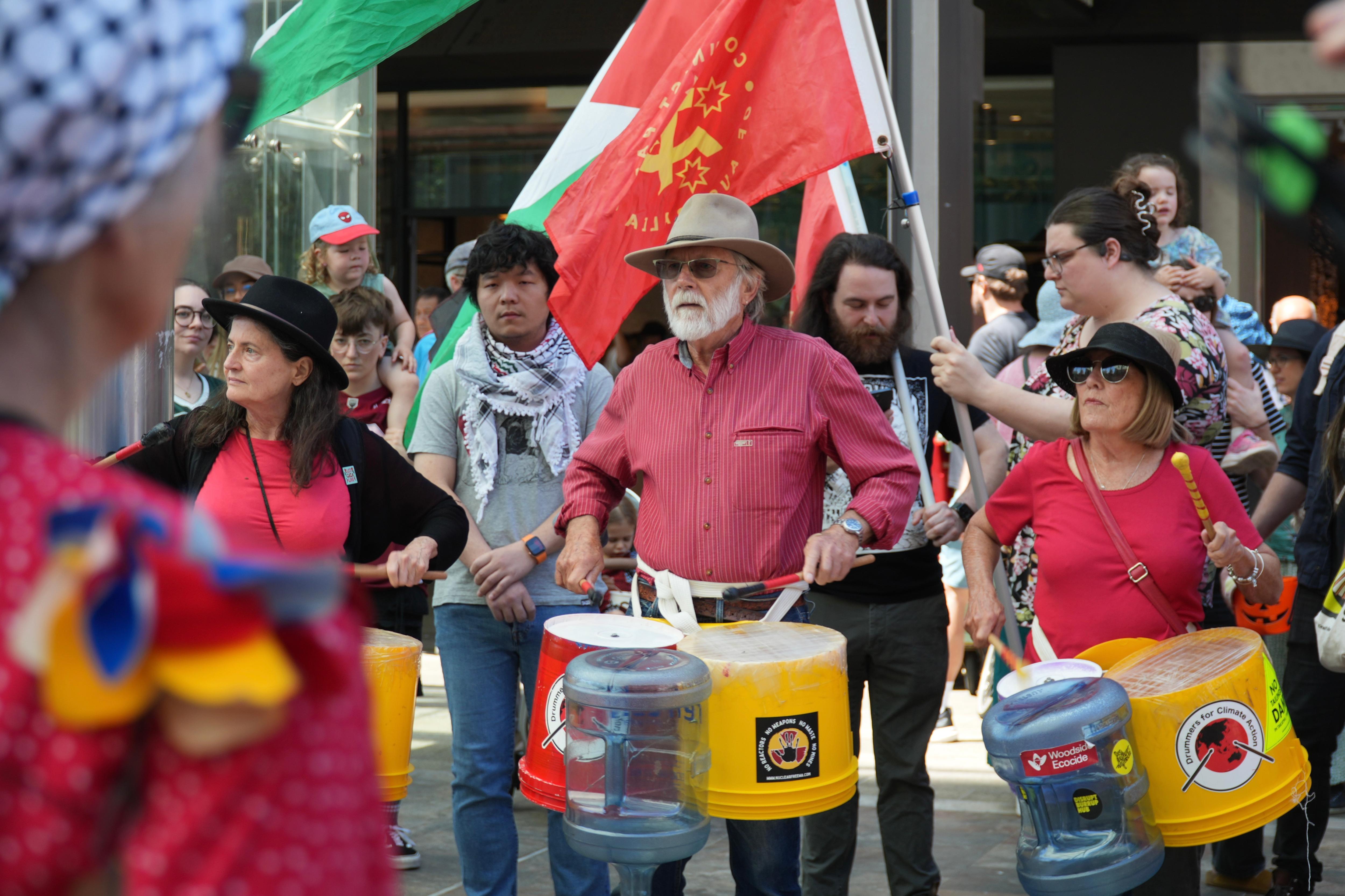 protesters in perth beat drums at a pro-palestine rally in the cbd