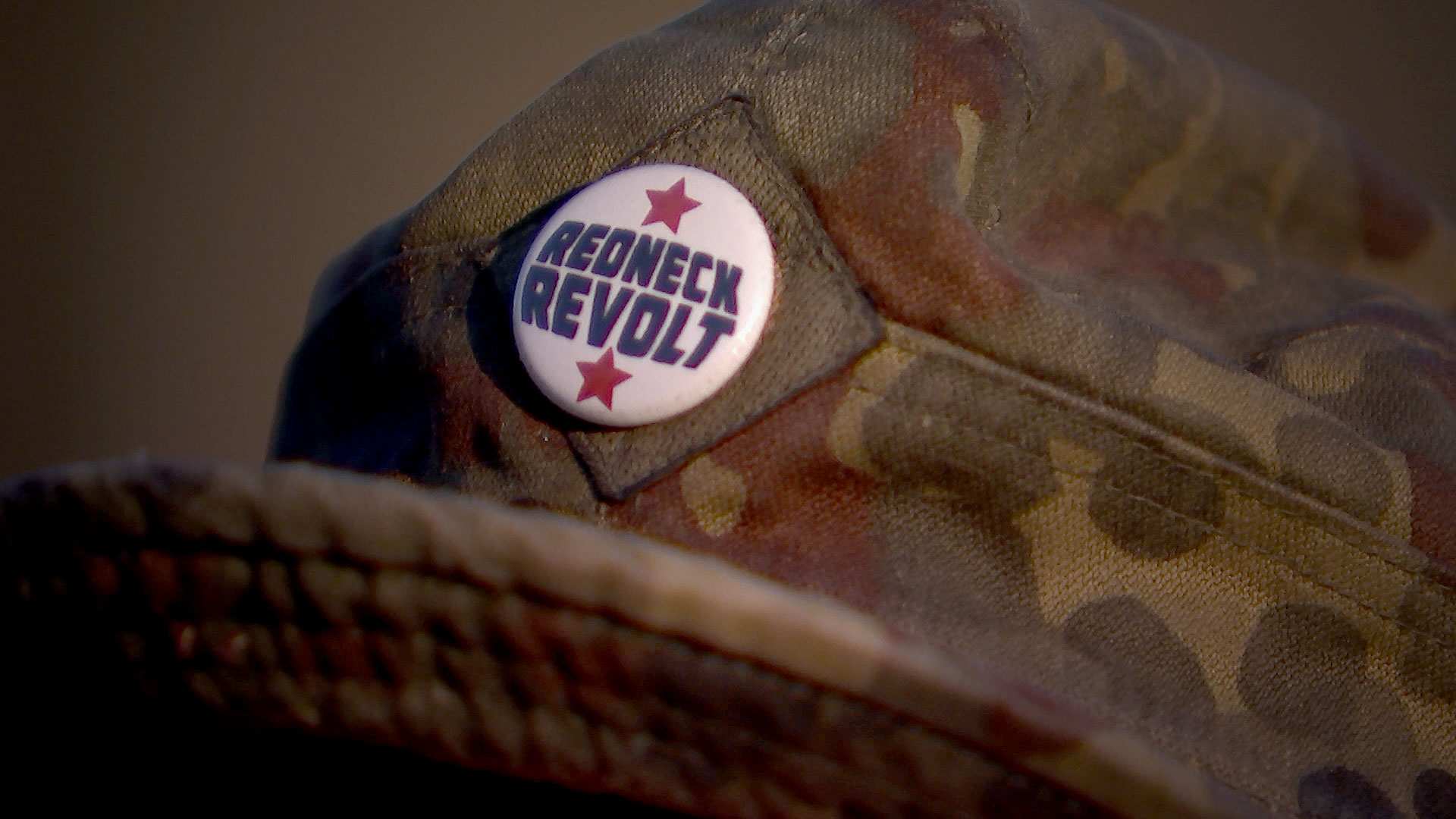A Redneck Revolt badge attached to a member's hat.