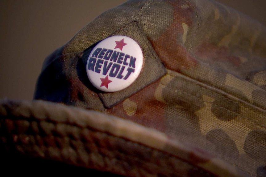A Redneck Revolt badge attached to a member's hat.