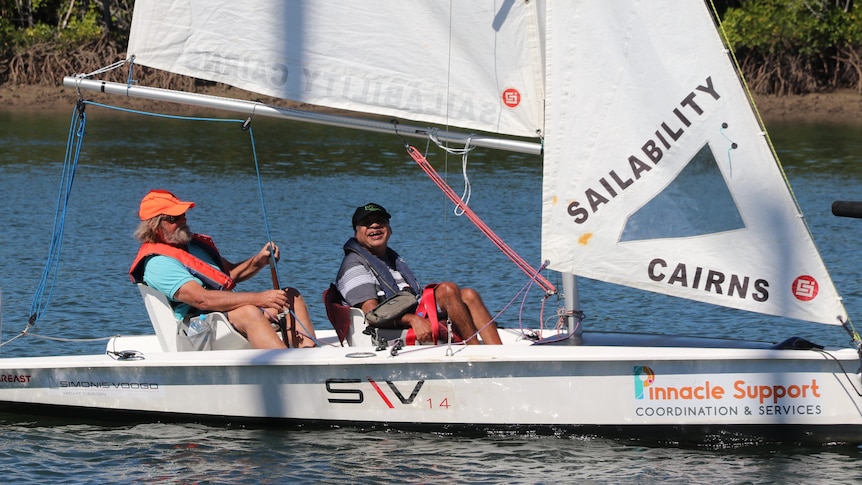 Two people on a small sailboat