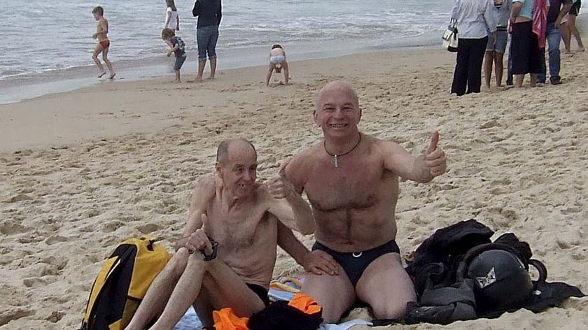 Convicted peadophile Dennis Ferguson, left, sits on Coogee Beach with Brett Collins