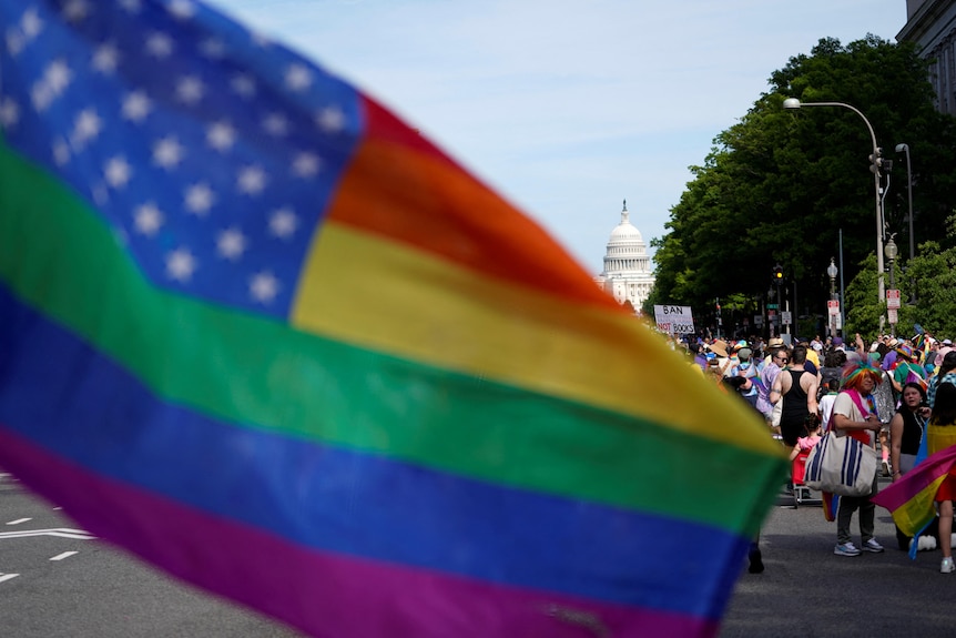 A pride flag before Capitol HIll 