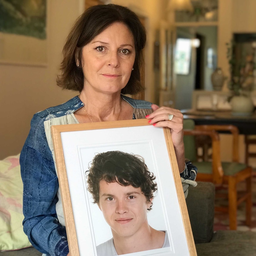 Loretta Gabriel holding a photo of her son Sam.