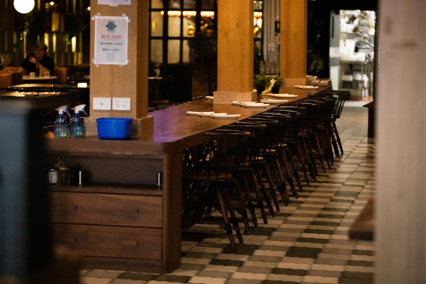 Empty seats in a restaurant with dim lighting.