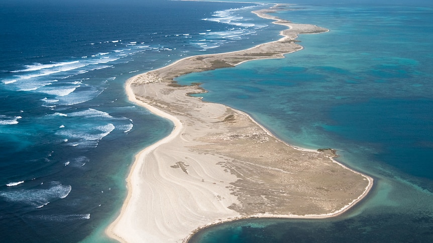 An aerial view of a remote sandy island.