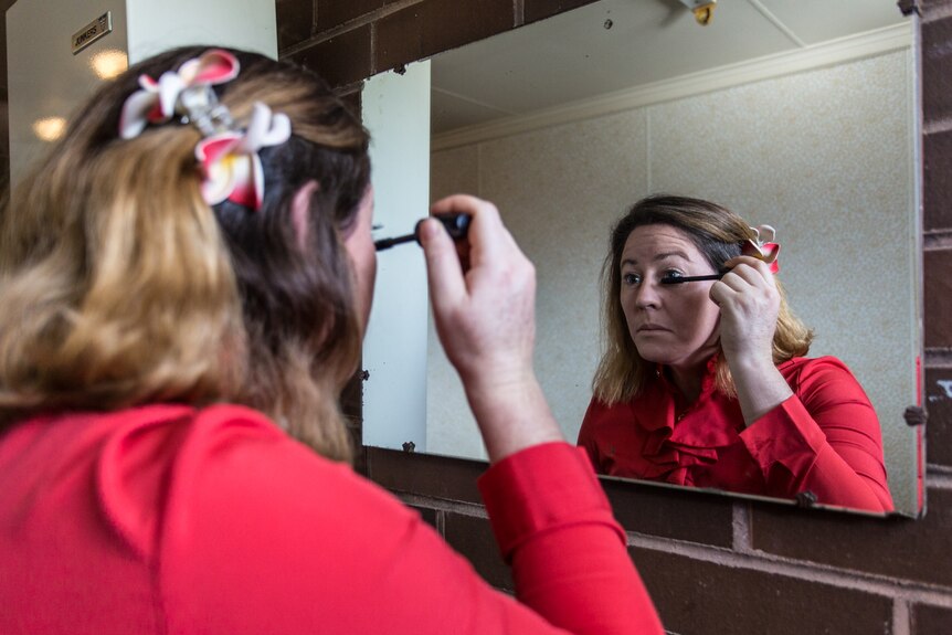 Kerrin Shortis applies make-up in the mirror