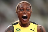 A Jamaican female sprinter celebrates after crossing the finish line to win gold at the Tokyo Olympics.