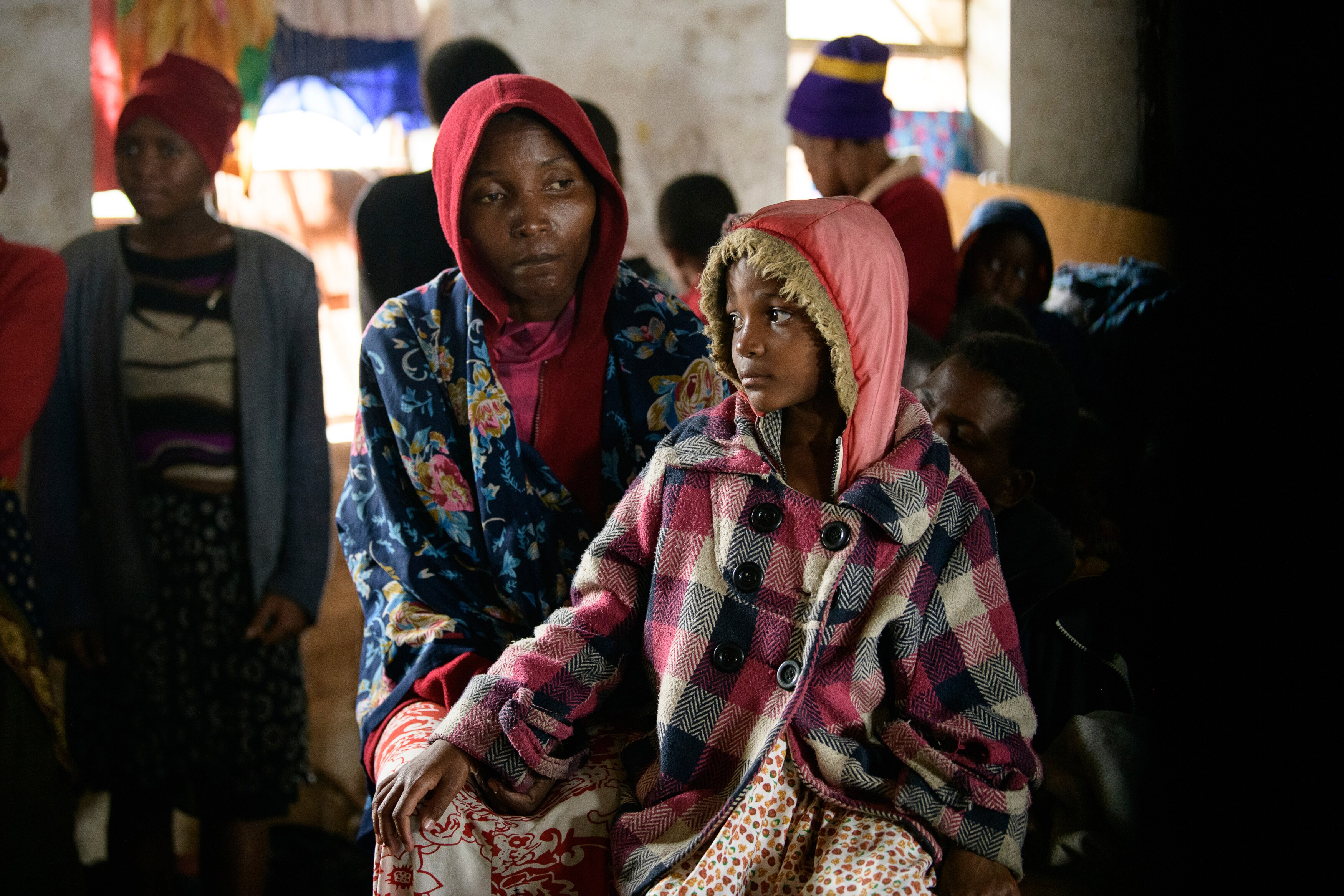 A mother and her child sit at a displacement centre in Blantyre, Malawi.