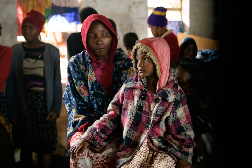 A mother and her child sit at a displacement centre in Blantyre, Malawi.